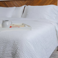 Photo of a classic and elegant bedroom highlighting white-on-white luxury and texture featuring ...