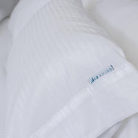 Photo of luxurious white-on-white sateen stripe pillowcases from the ComfortCore collection, show...