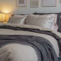 Photo of a bedroom with a plush bed featuring a QuickZip Fitted Sheet and Sand Flannel New-Way Du...