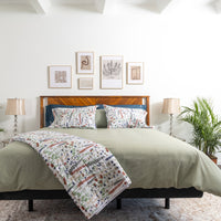 A photo of a full bedding set comprised of a Moss green Percale cotton duvet cover and a variety ...