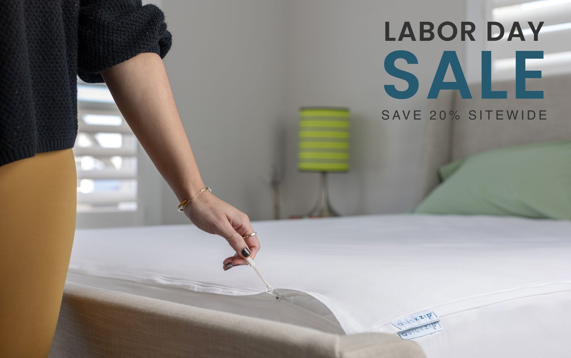 Person zipping fitted sheet with 'Labor Day Sale' text overlay